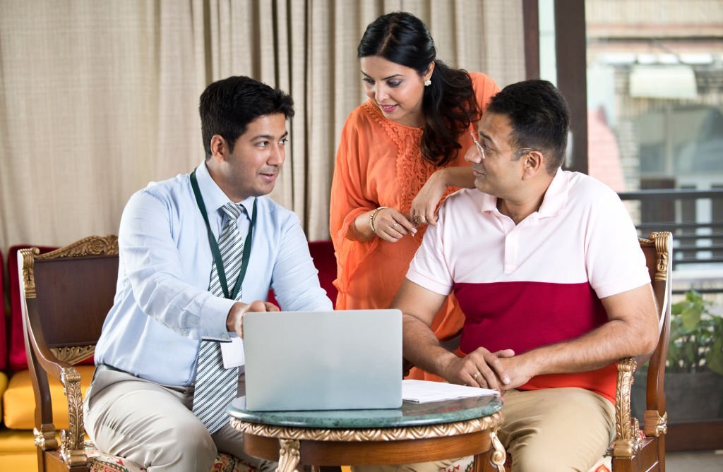 Financial advisor discussing with Indian family at home